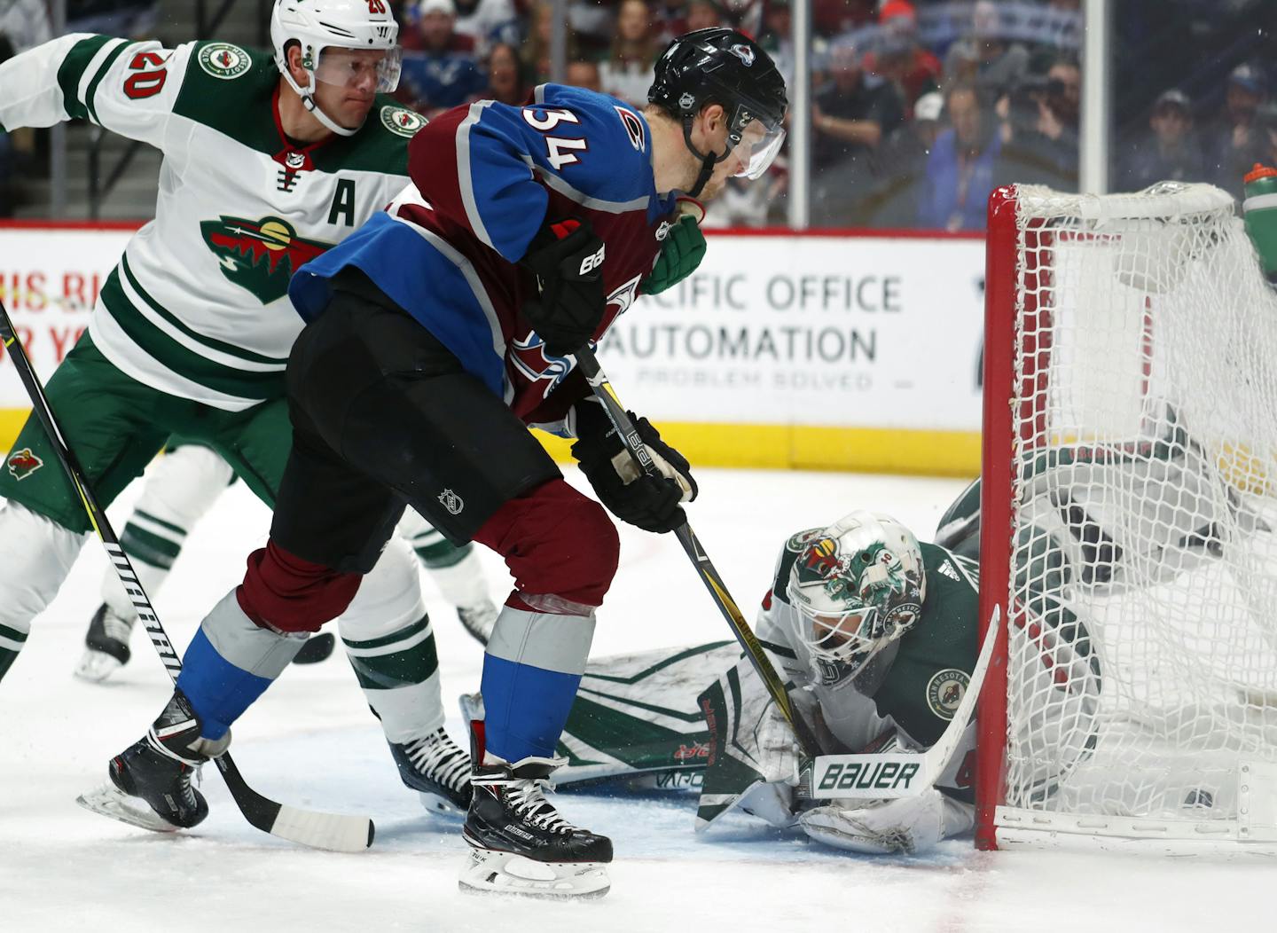 Colorado Avalanche center Carl Soderberg, center, of Sweden, pushes the puck past Minnesota Wild goaltender Devan Dubnyk, right, for a goal as defenseman Ryan Suter watches during the third period of an NHL hockey game Saturday, Jan. 6, 2018, in Denver. The Avalanche won 7-2. (AP Photo/David Zalubowski)