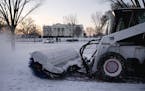 A worker with the National Park Service sweeps snow along Pennsylvania Avenue in front of the White House in Washington, Thursday, Jan. 21, 2016, afte