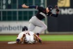 The Astros' Jeremy Peña steals second base as Twins second baseman Edouard Julien reaches for the throw during the sixth inning Sunday in Houston.
