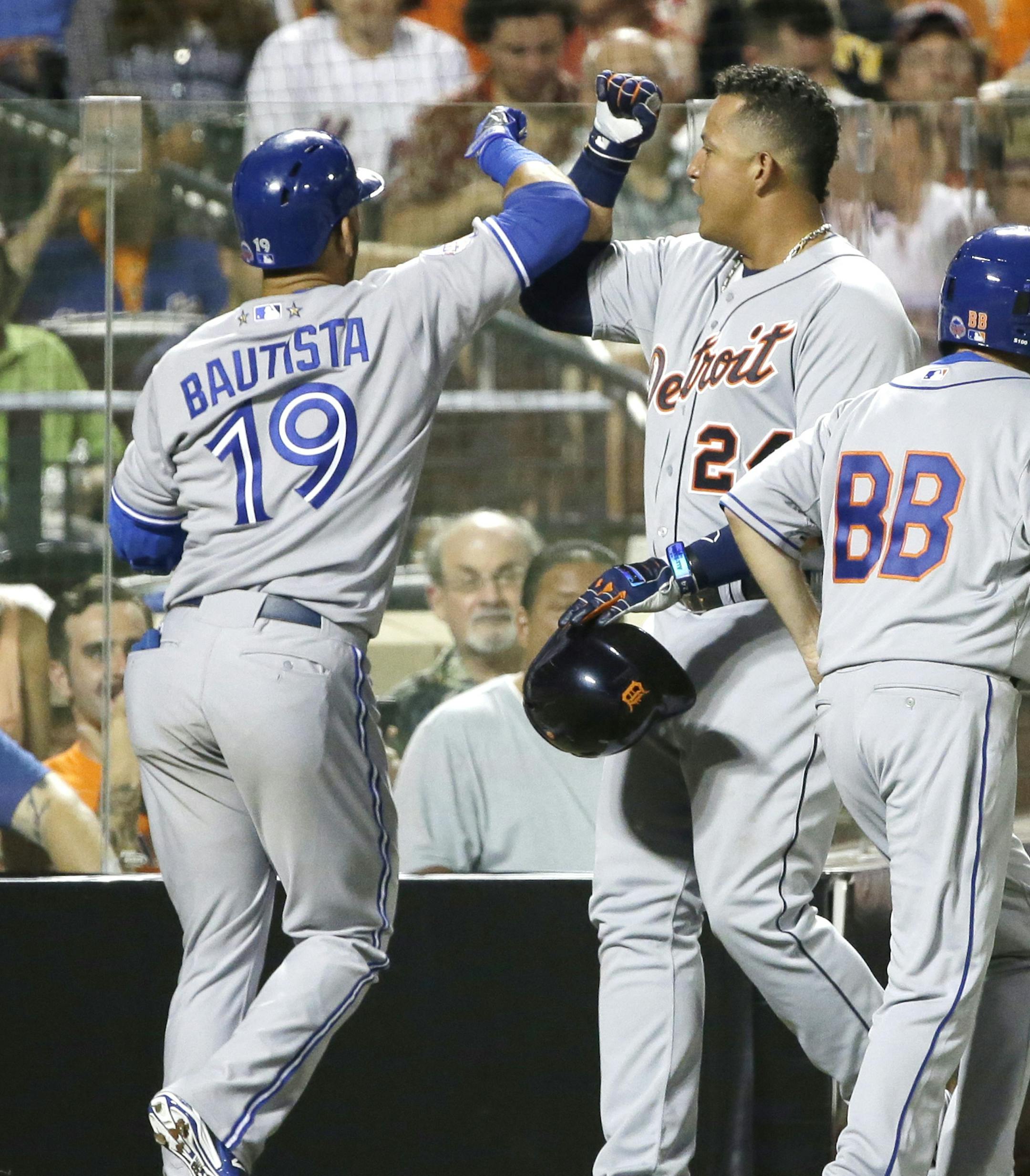 American Leagueís Miguel Cabrera, of the Detroit Tigers, is congratulated by American Leagueís Jose Bautista (19), of the Toronto Blue Jays, after scoring on Bautista's sacrifice fly during the fourth inning of the MLB All-Star baseball game, on Tuesday, July 16, 2013, in New York.(AP Photo/Matt Slocum)