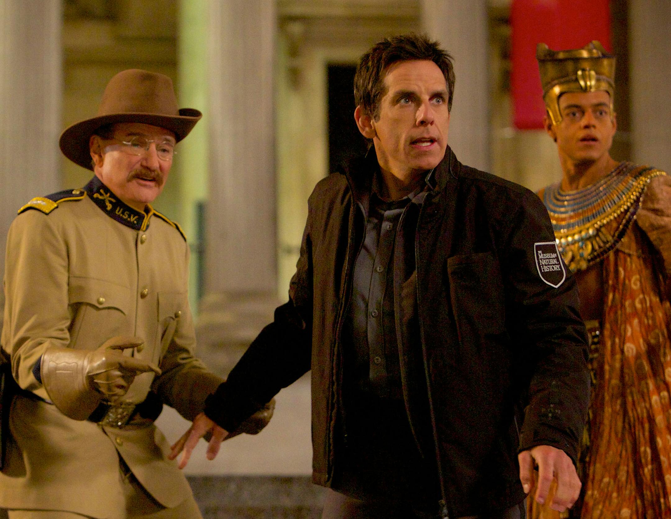 Night at the Museum: Secret of the Tomb From left) Atilla the Hun (Patrick Gallagher), Teddy Roosevelt (Robin Williams), Larry Daley (Ben Stiller) and Ahkmenrah (Rami Malek) react to an unexpected turn of events. Photo credit: Kerry Brown TM and © 2014 Twentieth Century Fox Film Corporation. †All Rights Reserved. †Not for sale or duplication.