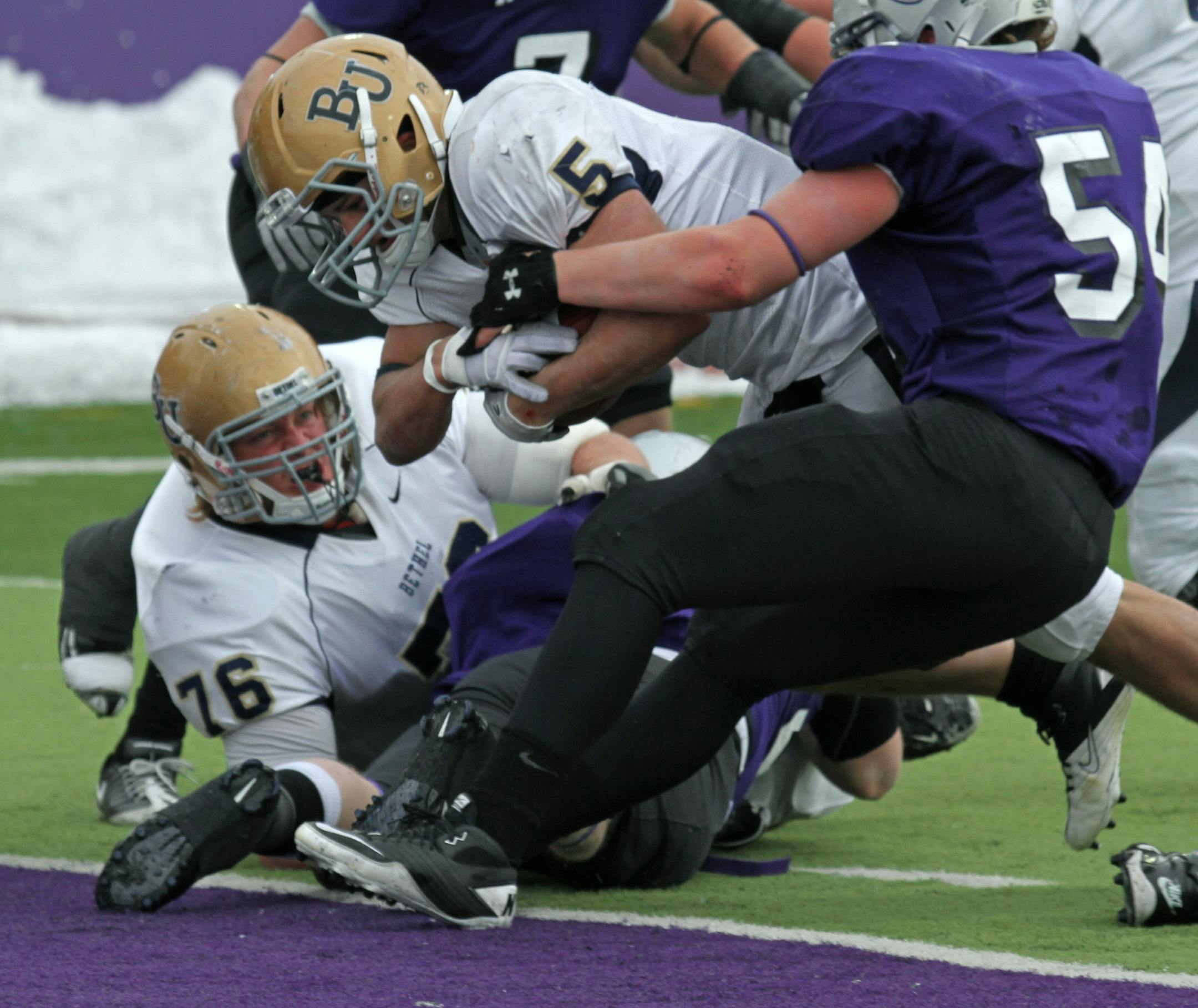 St. Thomas vs Bethel. (center) Bethel running back Logan Flannery carried the ball in for a touchdown as St. Thomas Tony Danna defended.