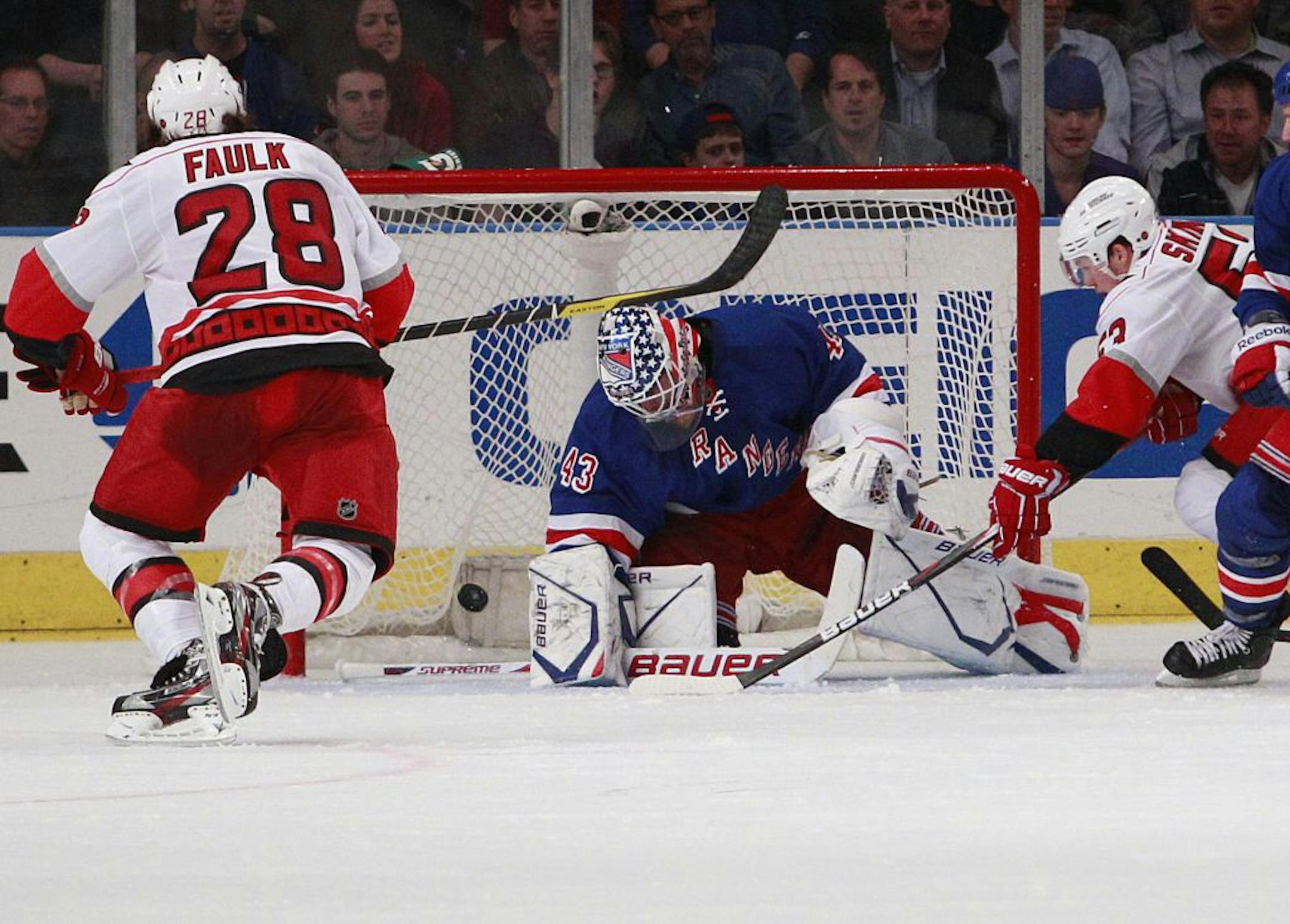 New York Rangers goalie Martin Biron watches as a puck hit by Carolina Hurricanes' Tim Brent gets past him for a goal as teammates Jeff Skinner, right, and Justin Faulk, left, watch during the second period of an NHL hockey game on Tuesday, March 13, 2012, in New York.