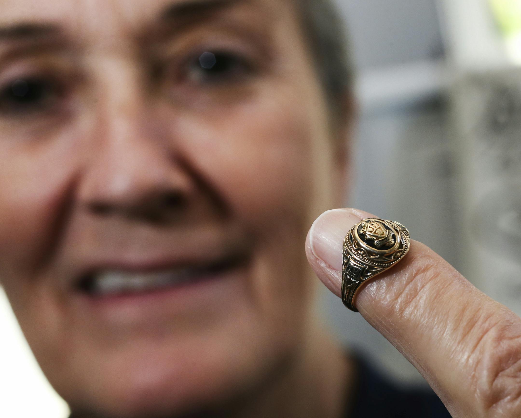 In this Oct. 16, 2018, photo, Barb Nelson, of Rochester, Minn., holds a 1955 class ring that she found in 1973 and is looking for the owner. Barb Nelson spotted the ring in 1973 while riding a horse over to her neighbor’s house. After initially failing to track down the ring’s owner, she set it aside in a jewelry box. Nelson recently came across the ring again and is hoping to find answers. (Andrew Link/The Rochester Post-Bulletin via AP)