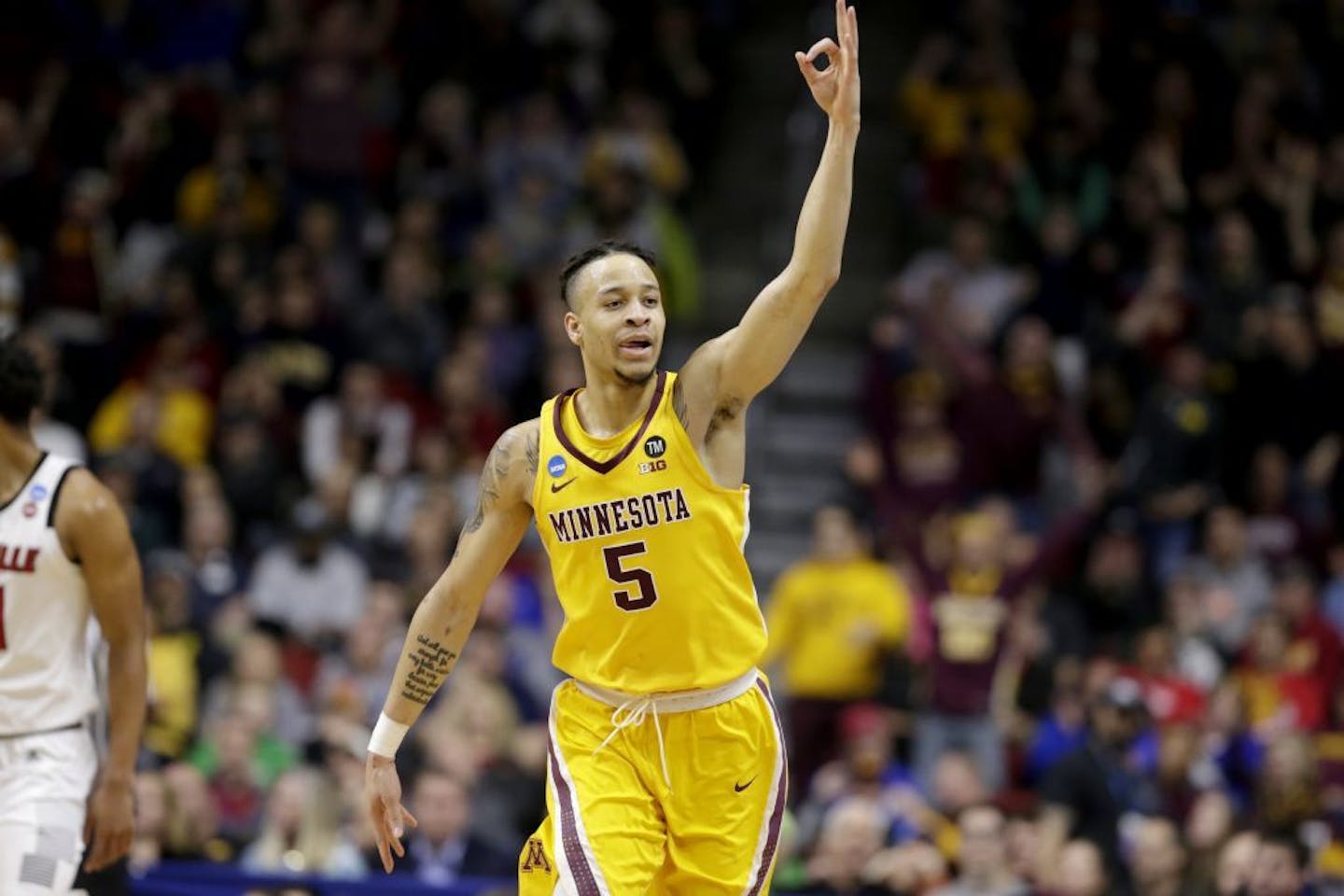 Minnesota's Amir Coffey (5) celebrates a three-point basket during the first half against Louisville. It was one of 11 by the Gophers, who ranked near the bottom of the 353 teams in Division I basketball in that statistic.