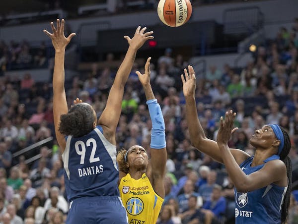 Minnesota Lynx Damiris Dantas, left, and Sylvia Fowles, right, blocked Chicago's Cheyenne Parkers shot under the net during the first quarter as the L