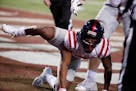 Mississippi wide receiver Elijah Moore's peeing-dog celebration after scoring a touchdown with four seconds to play led to a missed extra point and hi