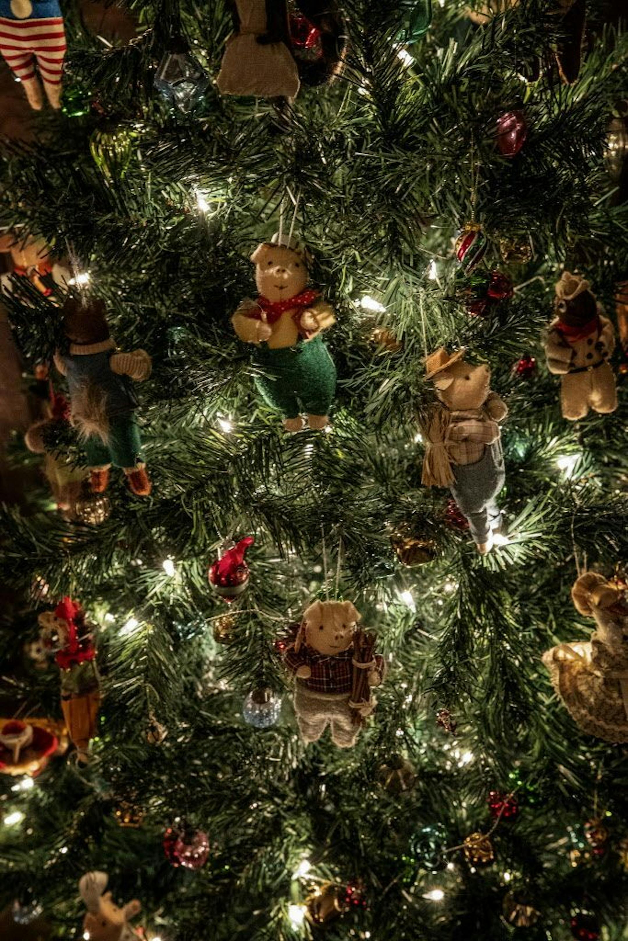 The "pub" tree is filled with whimsical fabric ornaments depicting "The Three Little Pigs" and other storybook characters.