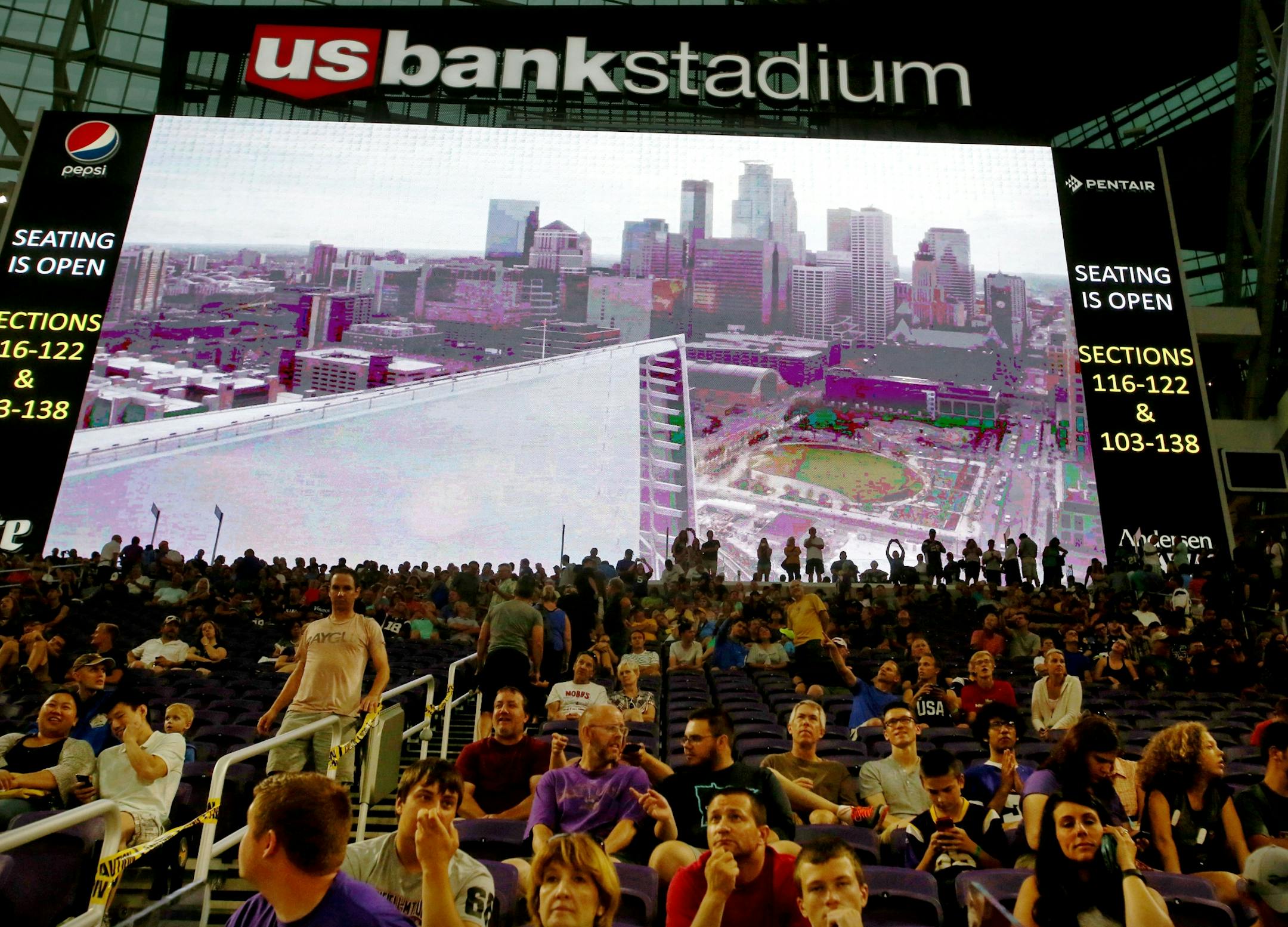 A large video display warned Vikings fans of a storm warning as a large crowd was on hand during a storm at the public opening at the U.S. Bank Stadium Saturday, July 23, 2016, in Minneapolis, MN.