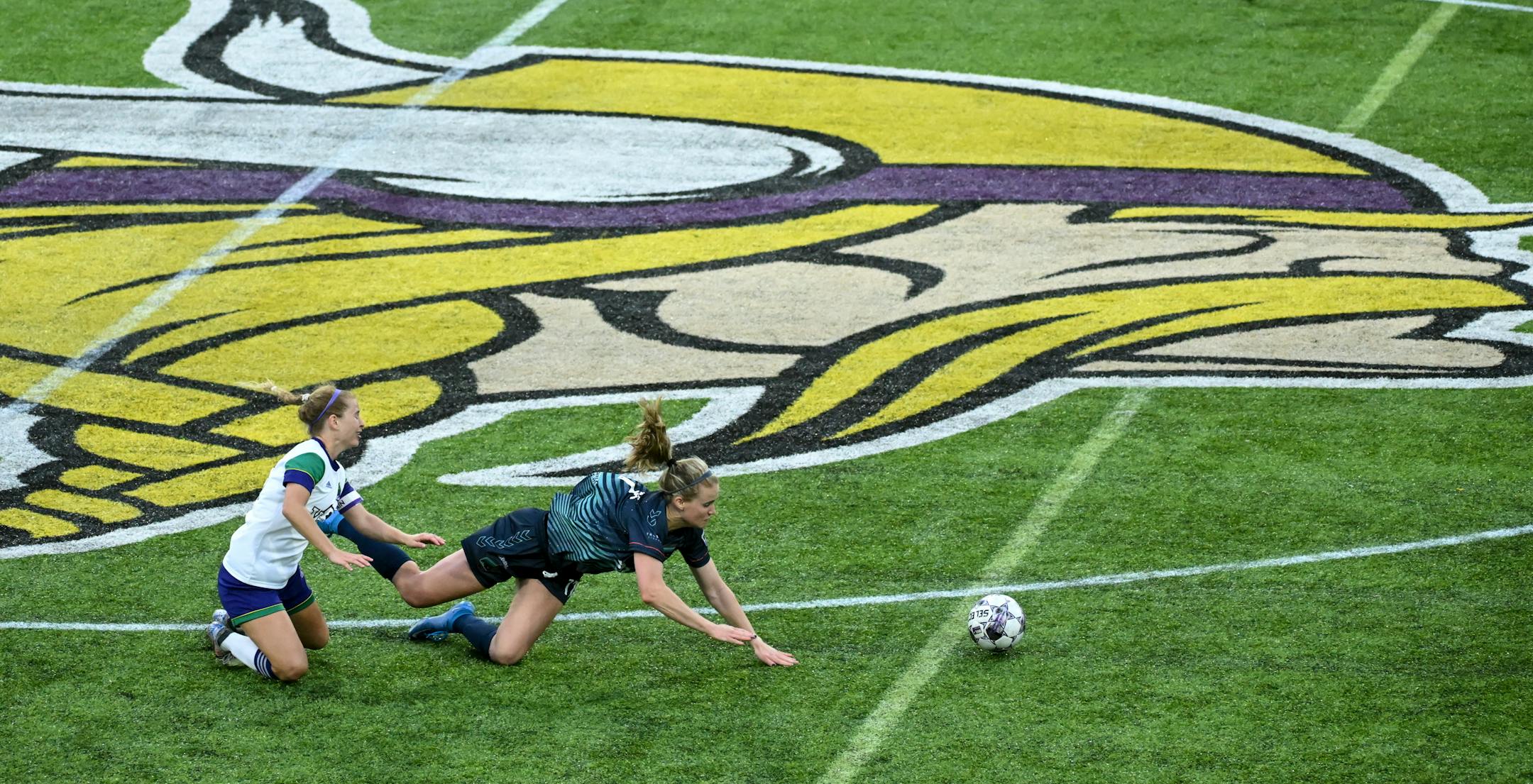 Green Bay's Brianna Messner trips Minnesota's Morgan Turner. for a yellow card during the second half.