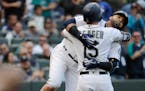 Seattle Mariners' Nelson Cruz, right, hugs Kyle Seager after Cruz hit a solo home run against the San Diego Padres during the fifth inning of a baseba