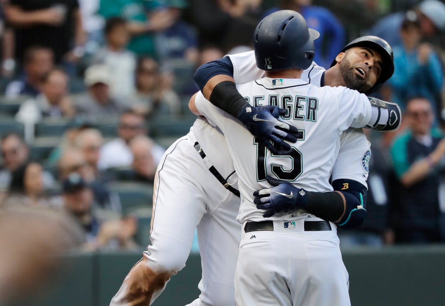 Seattle Mariners' Nelson Cruz, right, hugs Kyle Seager after Cruz hit a solo home run against the San Diego Padres during the fifth inning of a baseball game, Wednesday, Sept. 12, 2018, in Seattle. (AP Photo/Ted S. Warren)