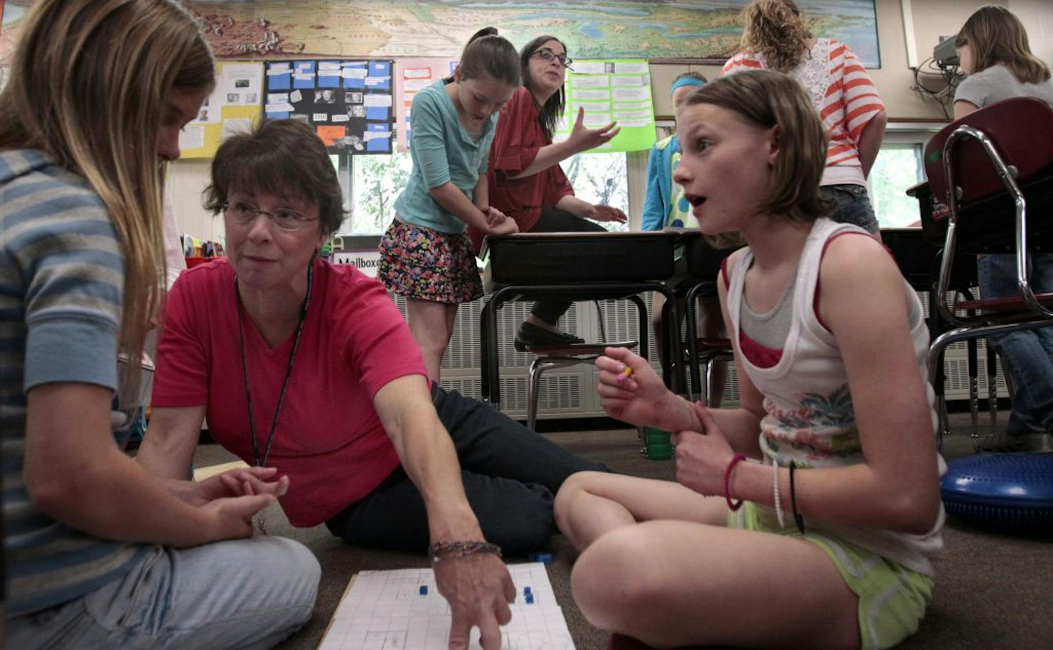 Glen Lake Elementary School fifth grade teacher Elizabeth Ogren (foreground) and Hannah Swaden worked with students on a project that involved planning a mock city, from the basic layout to housing, commerce and government. Hannah was a student of Liz's a few years ago, and is now becoming a teacher herself. Liz has been diagnosed with young Parkinson's disease and will retire at the end of this year. Hannah has been team-teaching with Liz all year. JIM GEHRZ•jgehrz@startribune.com Minnetonka/Ap