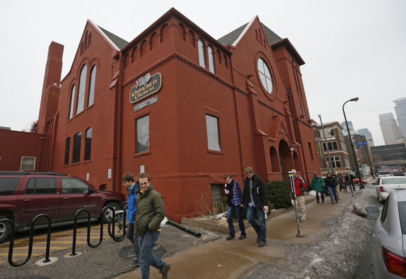 Members of the Hope Community Church walked pass the church after services Sunday, January 27, 2013 in Minneapolis, MN. Hope is one of four old, brick churches built in the 1800's standing the in the shadow of the Metrodome.