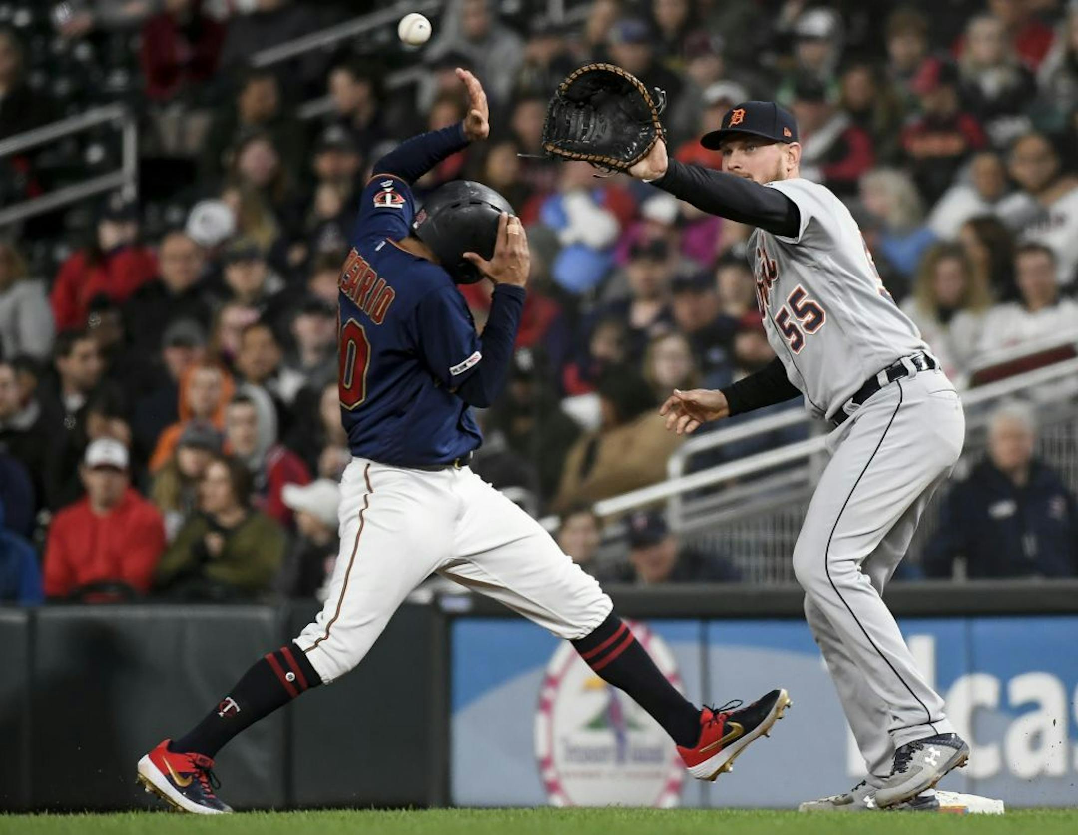 Minnesota Twins left fielder Eddie Rosario (20) tagged back to first base as Detroit Tigers first baseman John Hicks (55) hoped to get the tag in the bottom of the sixth inning.