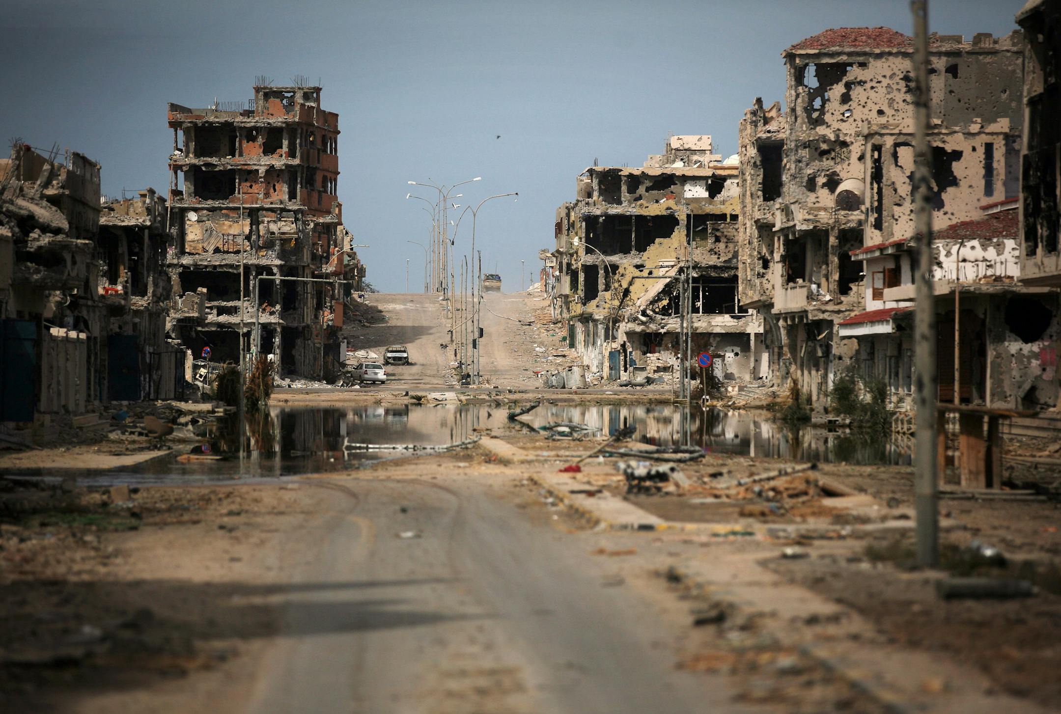 FILE - In this Saturday, Oct. 22, 2011 file photo, a general view of buildings ravaged by fighting in Sirte, Libya. From east and west, the forces of Libya's rival powers are each moving on the city of Sirte, vowing to free it from the hold of the Islamic State group. The danger is they could very well fight each other as well. Rather than becoming a unifying cause as the United States and Europe have hoped, the fight against the jihadi group threatens to cause greater fragmentation in Libya, wh