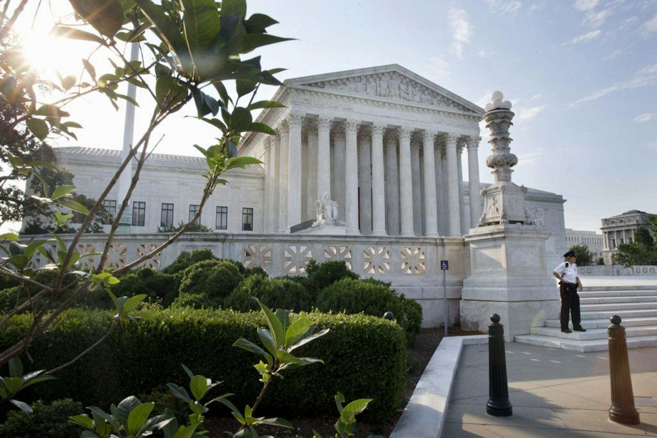Security guards the Supreme Court in Washington, Thursday June 25, 2015. The court is expected to hand down decisions today. Two major opinions, health care and gay marriage, are among the remaining to be released before the term ends at the end of June.