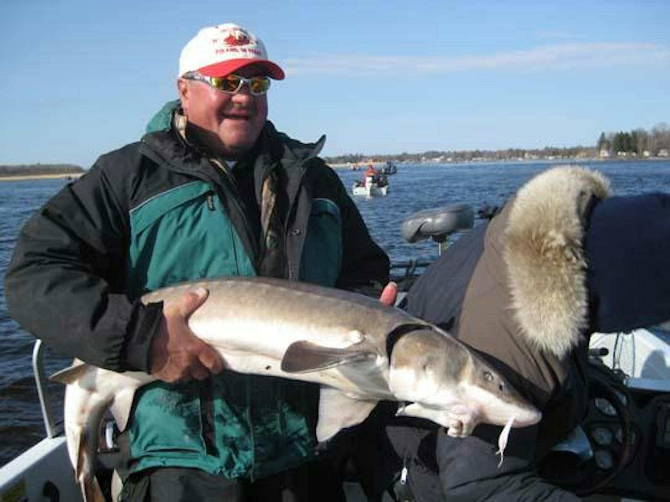 Kris Moen of Minneapolis with his winning 60-inch sturgeon