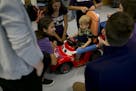 Spencer Oswald, 2, sits in a model car he is being fitted for by Northwestern University physical therapy students on Friday, June 15, 2018 in Chicago