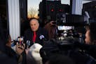Rudy Giuliani speaks to reporters before a campaign event for Florida Gov. Ron DeSantis in Manchester, N.H., Jan. 21, 2024.