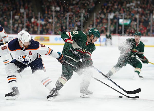 Minnesota Wild left wing Tyler Ennis (63) got control of the puck before spinning around and passing to a teammate in the second period. He was defend