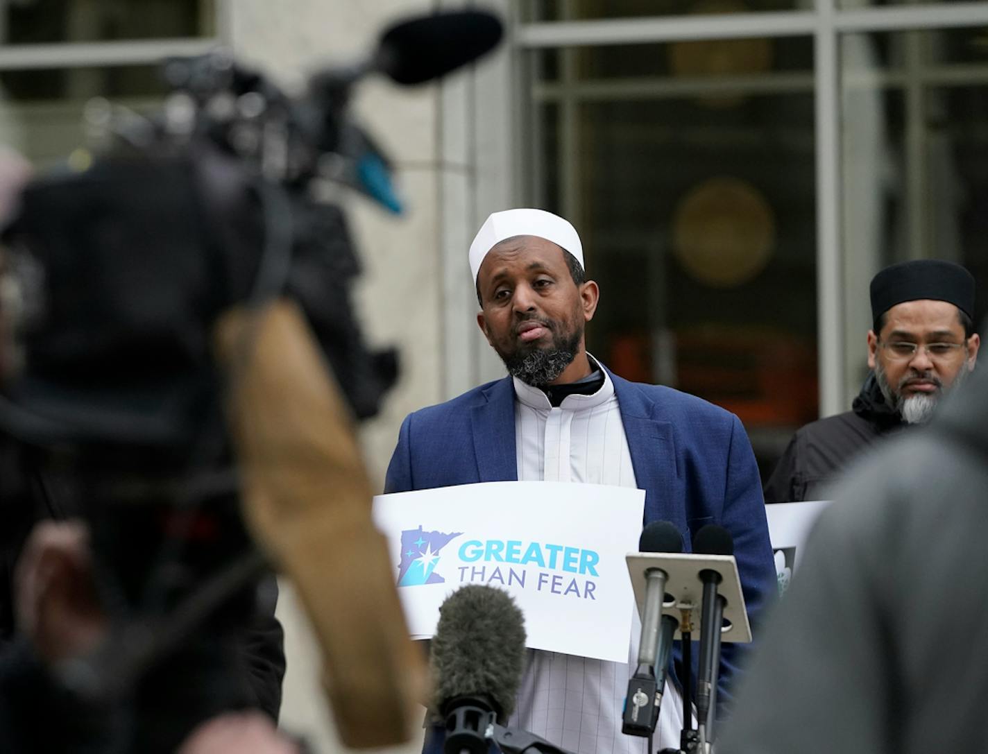 Before the sentencing, clergy members seeking restorative justice, including Imam Omar Mohamed, Imam of Dar Al-Farooq Islamic Center, Bloomington, at microphone, addressed media members, seeking compassion and forgiveness for the two young men who took part in the bombing of the Dar Al-Farooq Islamic Center in 2017 and seen outside the U.S. Federal Courthouse Tuesday, April 12, 2022 in St. Paul, Minn. ]