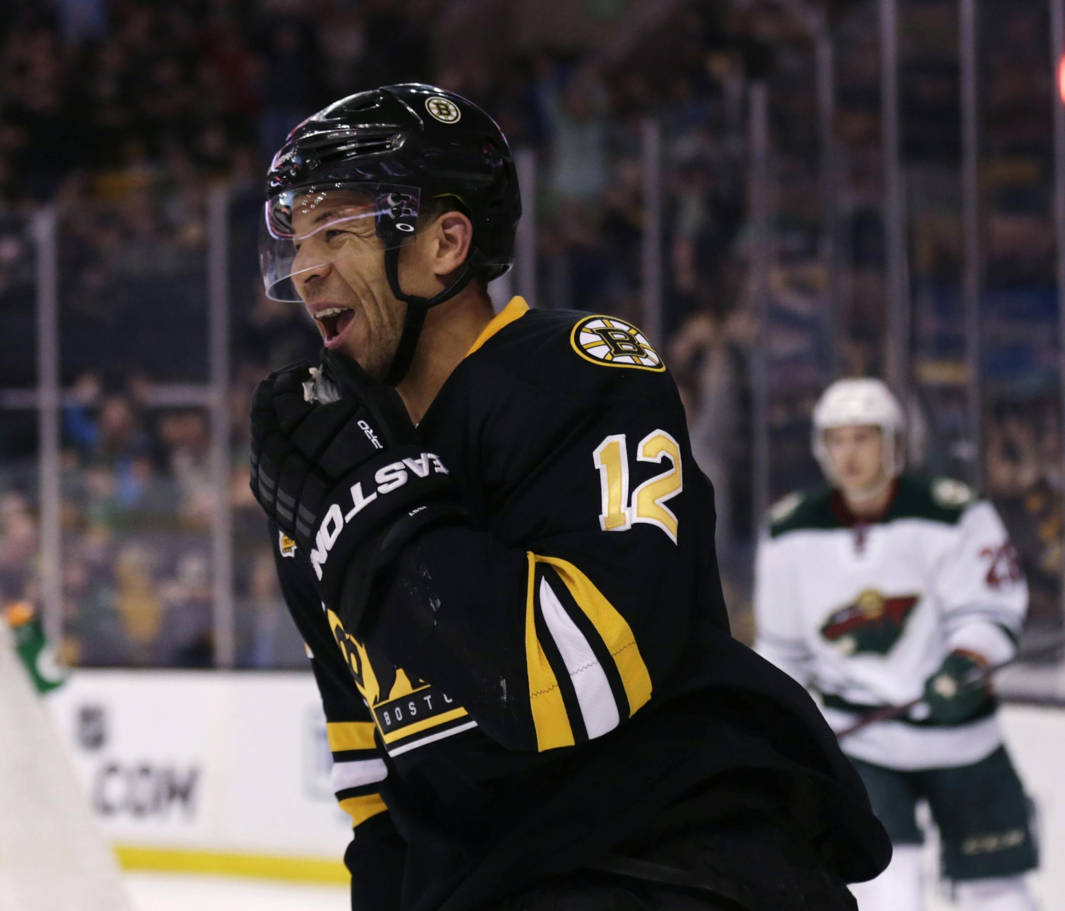 Boston Bruins right wing Jarome Iginla (12) smiles after his goal against the Minnesota Wild during the second period of an NHL hockey game, Monday, March 17, 2014, in Boston. Iginla had two goals in the Bruins 4-1 win. (AP Photo/Charles Krupa)