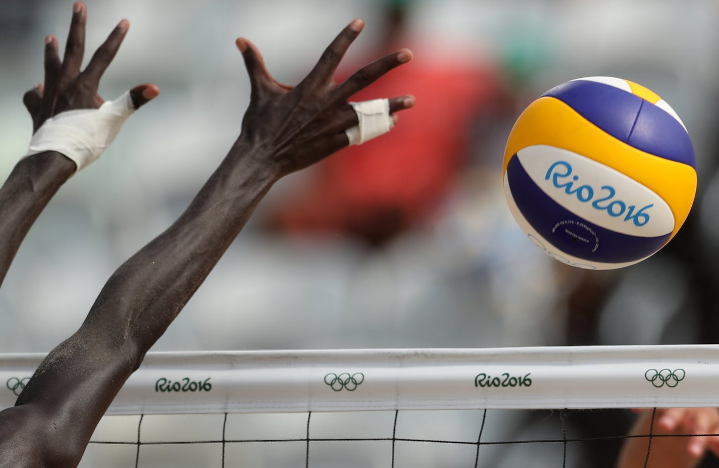 Qatar's Cherif Younousse Samba tries to block a ball during a men's beach volleyball match against Spain at the 2016 Summer Olympics in Rio de Janeiro, Brazil, Monday, Aug. 8, 2016. (AP Photo/Petr David Josek)