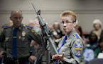 FILE - In this Jan. 28, 2013, file photo, firearms training unit Detective Barbara J. Mattson, of the Connecticut State Police, holds up a Bushmaster 