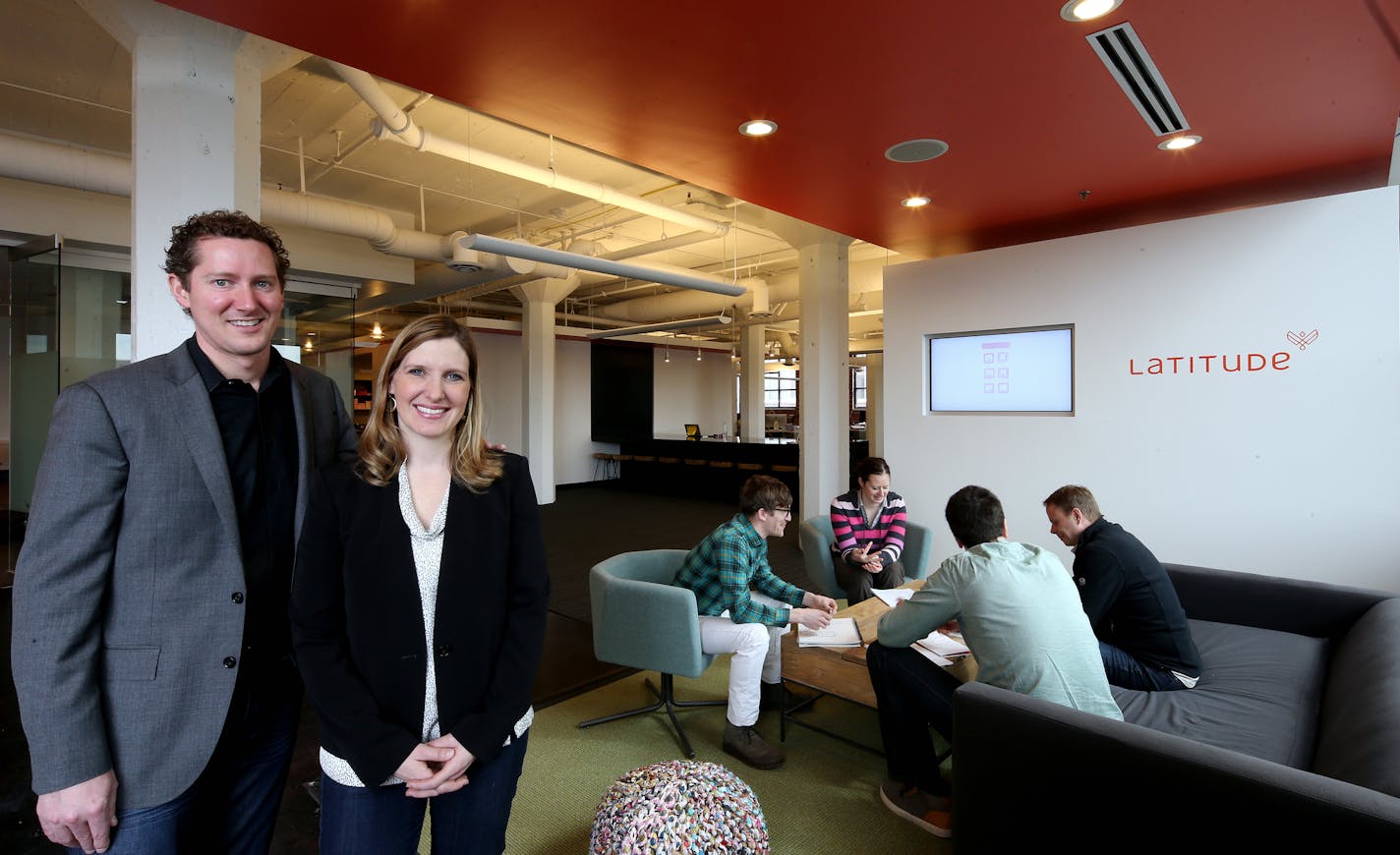 Jeremy and Krista Carroll (left) of Latitude inside their new work space. Creative team of Josh Witham (green plaid), Brenna Pileggi (red stripes) Eric Anthony (black shirt) and Kevin Hughes work on a project. ] JOELKOYAMA&#x201a;&#xc4;&#xa2;jkoyama@startribune Minneapolis, MN on March 17, 2014.