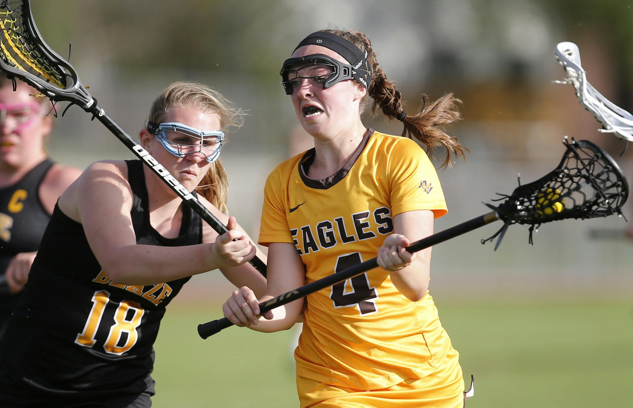 Katie Moynihan(4) of Apple Valley looked to score as Makaela Kallstrom(18) defended. ]At Apple Valley H.S. in a game between Apple Valley and Burnsville in girls' lacrosse. Richard Tsong-Taatarii/rtsong-taatarii@startribune.com