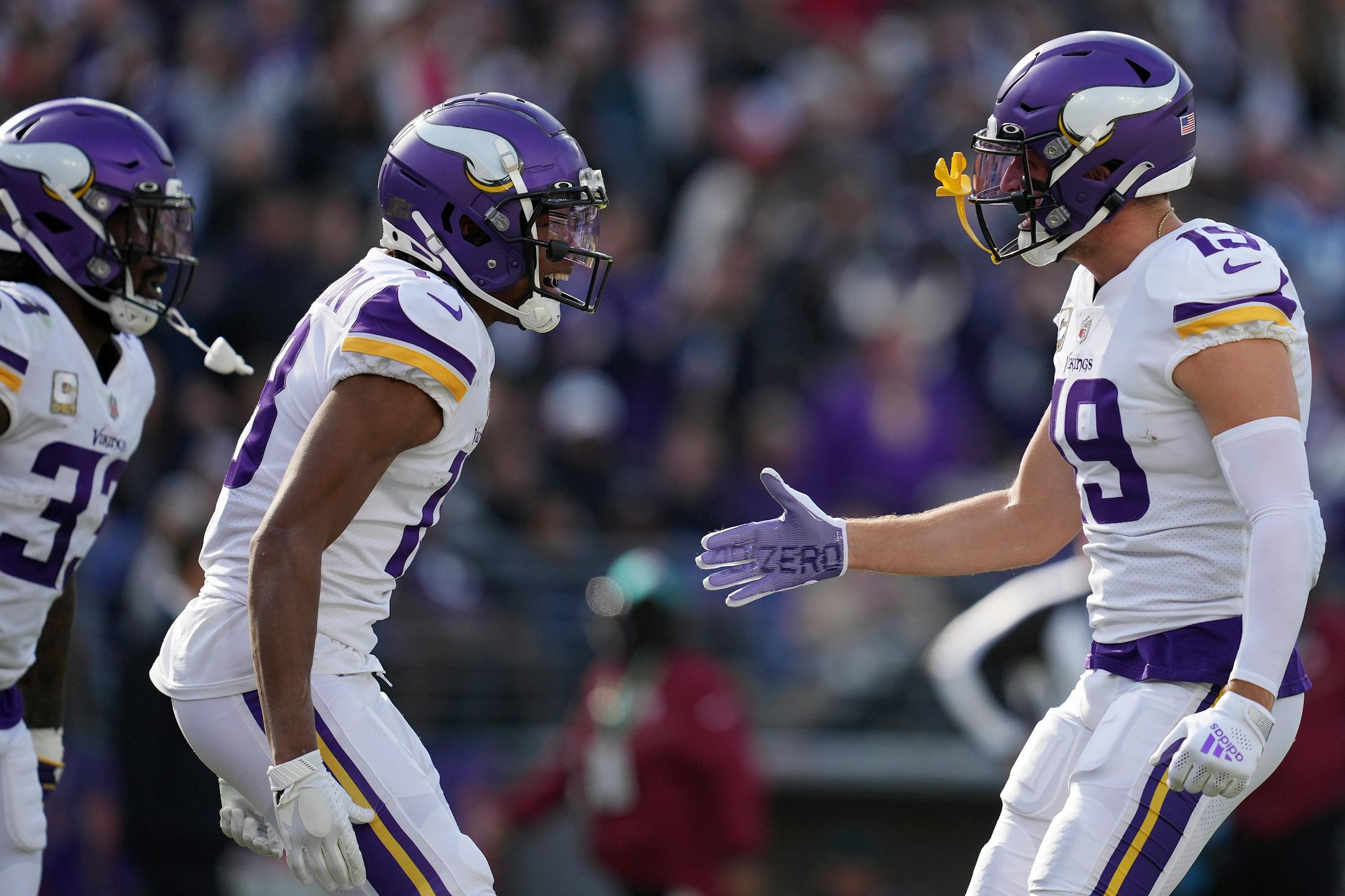 Vikings wide receiver Justin Jefferson (18) celebrates with fellow wide receiver Adam Thielen (19) after running in a 50-yard touchdown pass from quarterback Kirk Cousins (8) in the first quarter.