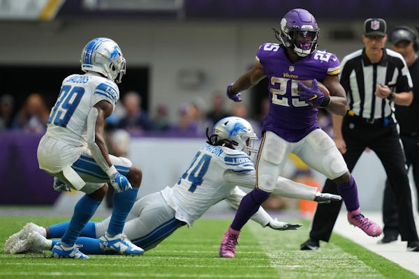 Vikings running back Alexander Mattison was pushed out of bounds by Lions linebacker Jalen Reeves-Maybin