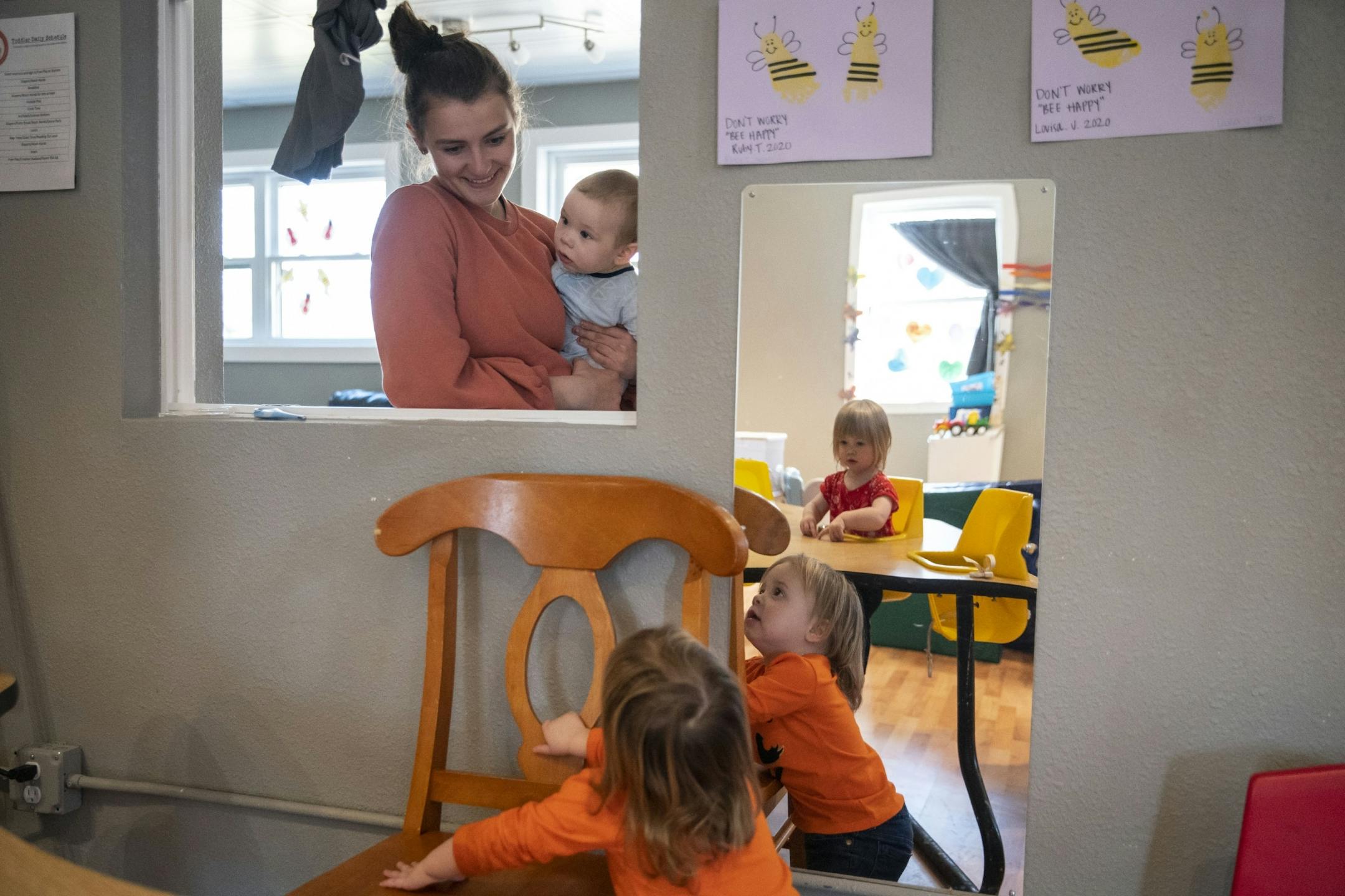 (From Left) Emily Bates played with Beckham, 8-months-old, while Charlotte and Ruby got ready for snack time at Aunty's Child Care in Duluth, MN on Thursday.