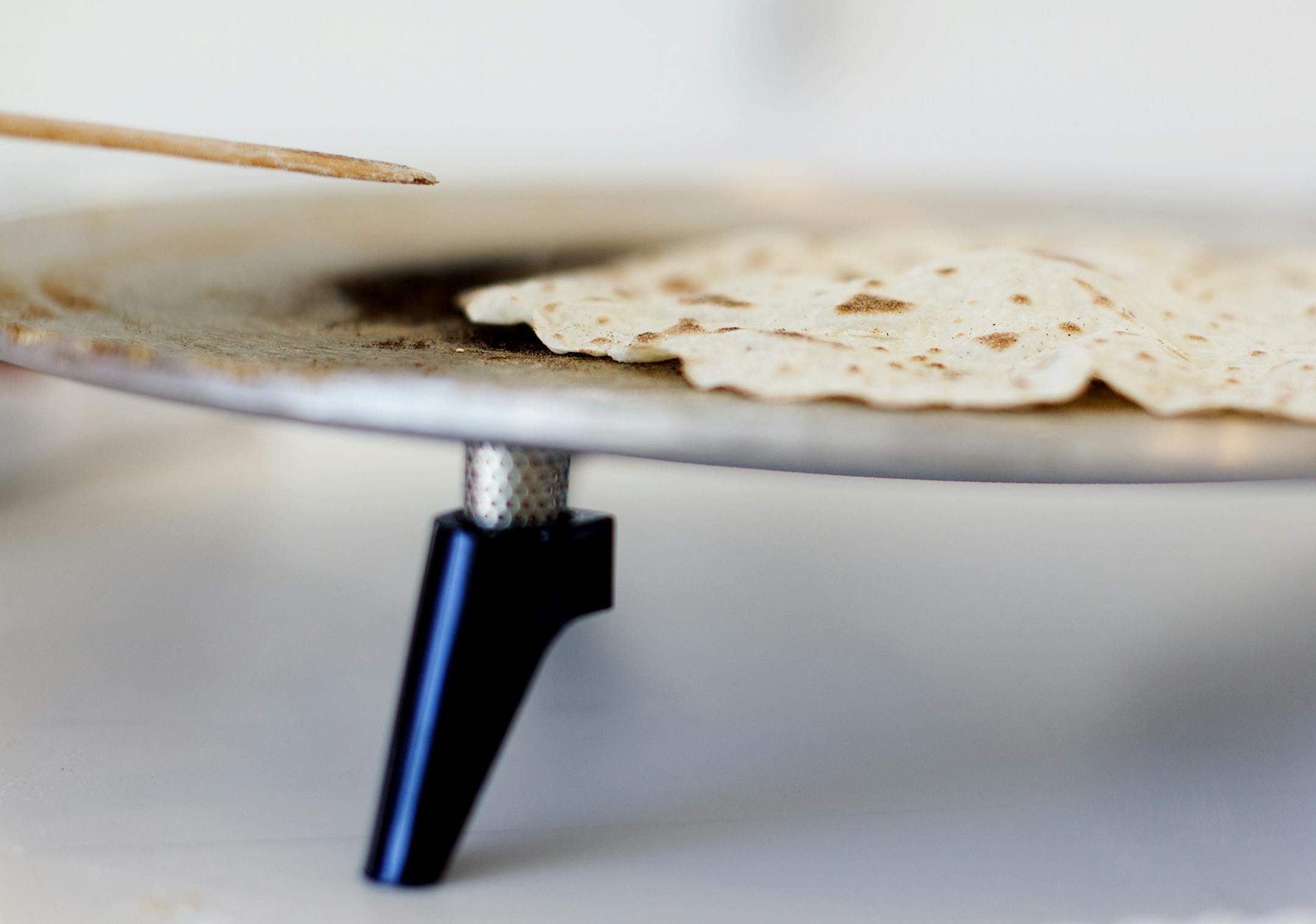 One sign of a perfectly-cooking lefse is the slight protrusion of an air pocket. The women of the Circle of Gratitude group from Minneapolis' Central Lutheran Church gathered to make lefse at the home of Rebecca Jorgenson Sundquist in Deephaven December 6, 2013. (Courtney Perry/Special to the Star Tribune)