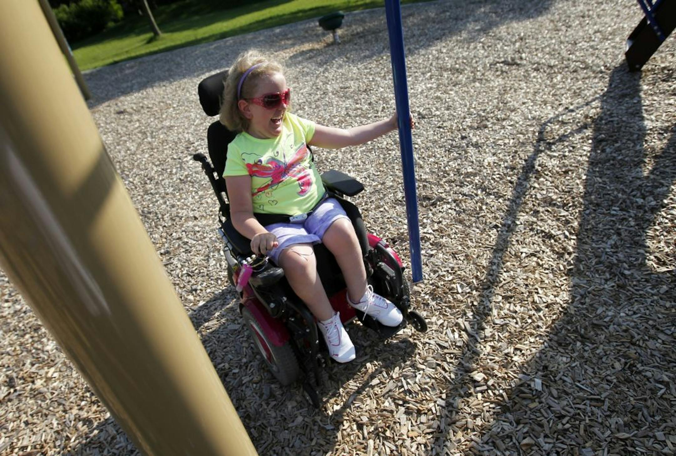 Sydney Gustafson, 10, spun around a pole at her local park on Tuesday. Sydney has spinal muscular atrophy, has used a wheelchair since she was 2. She will benefit from the new Madison's Place, an all inclusive playground being built in Woodbury.