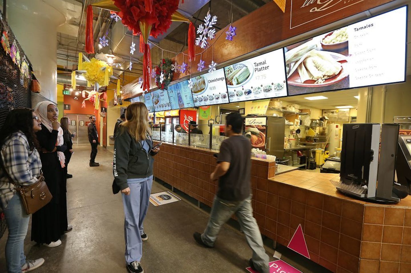 People made their way in and around the different food vendors during the lunch hour at the Midtown Global Market, Thursday, December 22, 2016 in Minneapolis, MN.