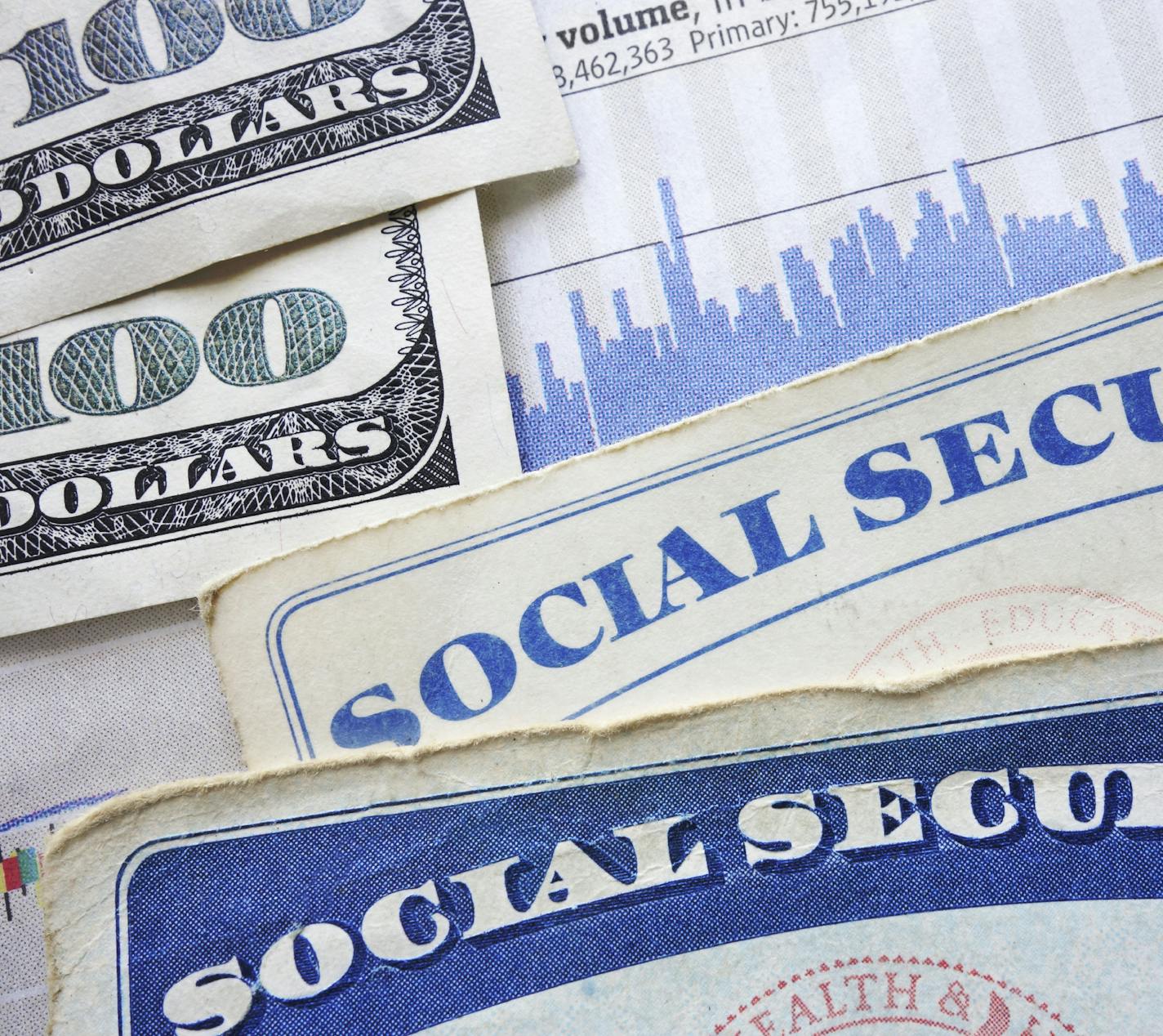 Social Security cards, cash and stock market chart