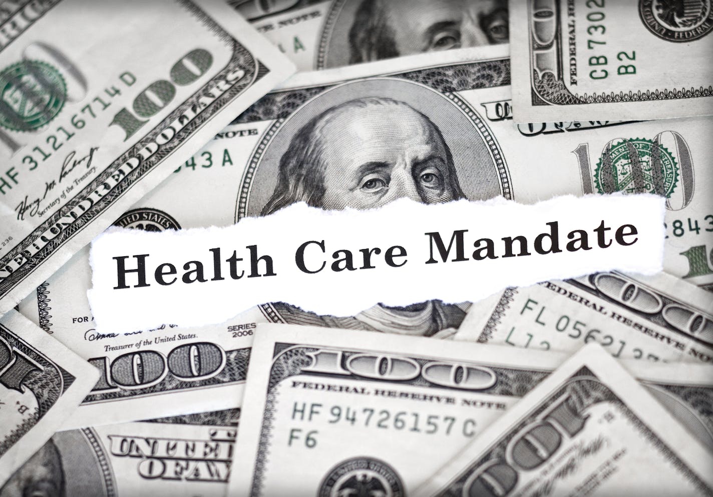 The words "Health Care Mandate" with hundred dollar bills in background.