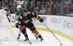 Anaheim Ducks' Pontus Aberg (20) is defended by Dallas Stars' Gavin Bayreuther during the second period of an NHL hockey game Wednesday, Dec. 12, 2018