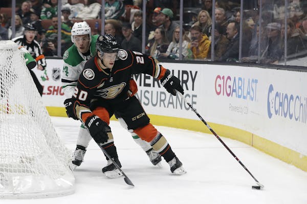 Anaheim Ducks' Pontus Aberg (20) is defended by Dallas Stars' Gavin Bayreuther during the second period of an NHL hockey game Wednesday, Dec. 12, 2018