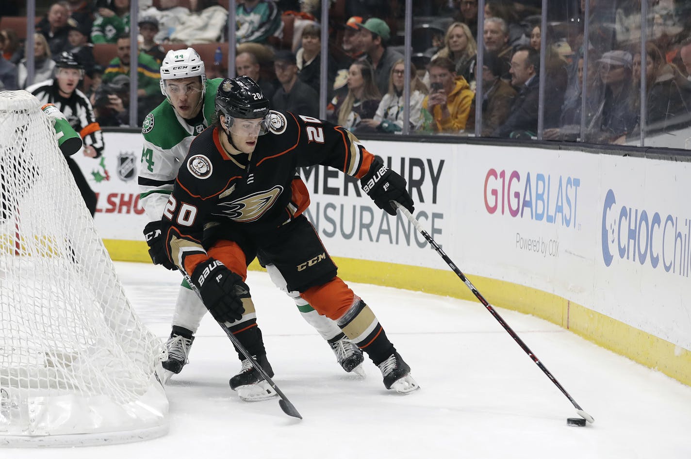 Anaheim Ducks' Pontus Aberg (20) is defended by Dallas Stars' Gavin Bayreuther during the second period of an NHL hockey game Wednesday, Dec. 12, 2018, in Anaheim, Calif. (AP Photo/Marcio Jose Sanchez)