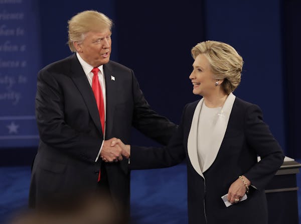 Republican presidential nominee Donald Trump shakes hands with Democratic presidential nominee Hillary Clinton following the second presidential debat