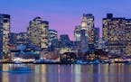 Boston city skyline is illuminated at dusk in 2012 as it reflects off the waters of Boston Harbor. The U.S. Olympic Committee picked Boston on Thursda