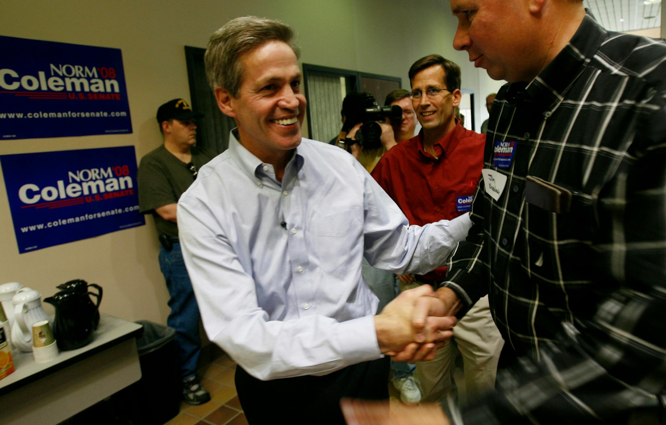 Republican Sen. Norm Coleman is greeted by a supporter during a campaign stop at the St. Cloud Area Chamber of Commerce.