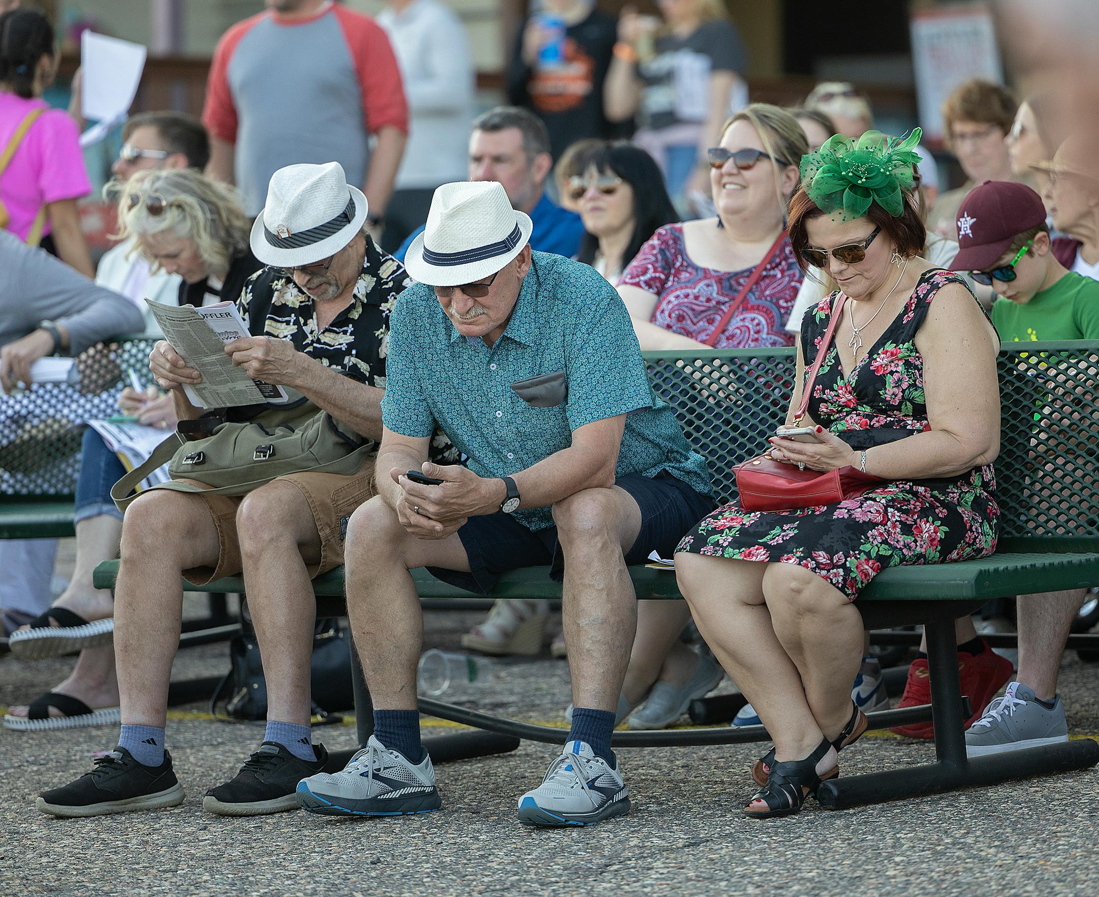 Race fans check out their race options before a race on opening night.