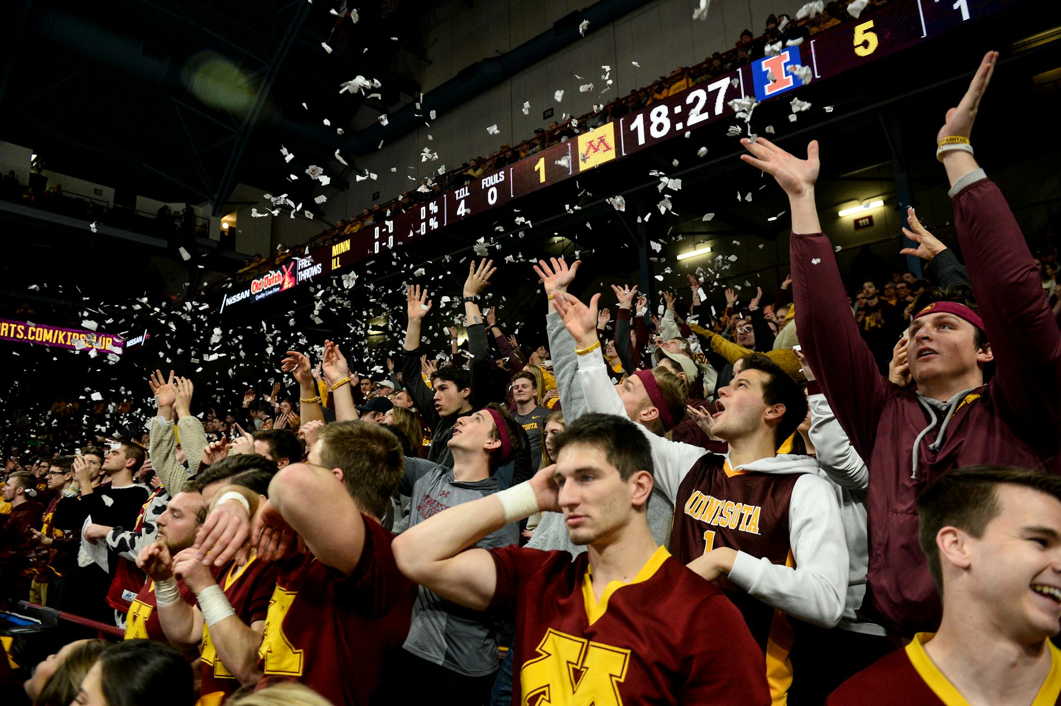 Minnesota Golden Gophers fans sitting in the student section tossed torn-up pieces of paper into the air.