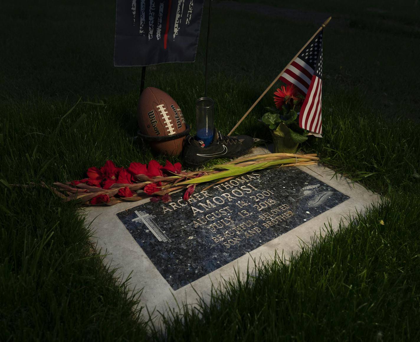 Archer's grave is frequently decorated with items he loved. His father, Don Amorosi, visits weekly to tend the grave and grieve for his son.