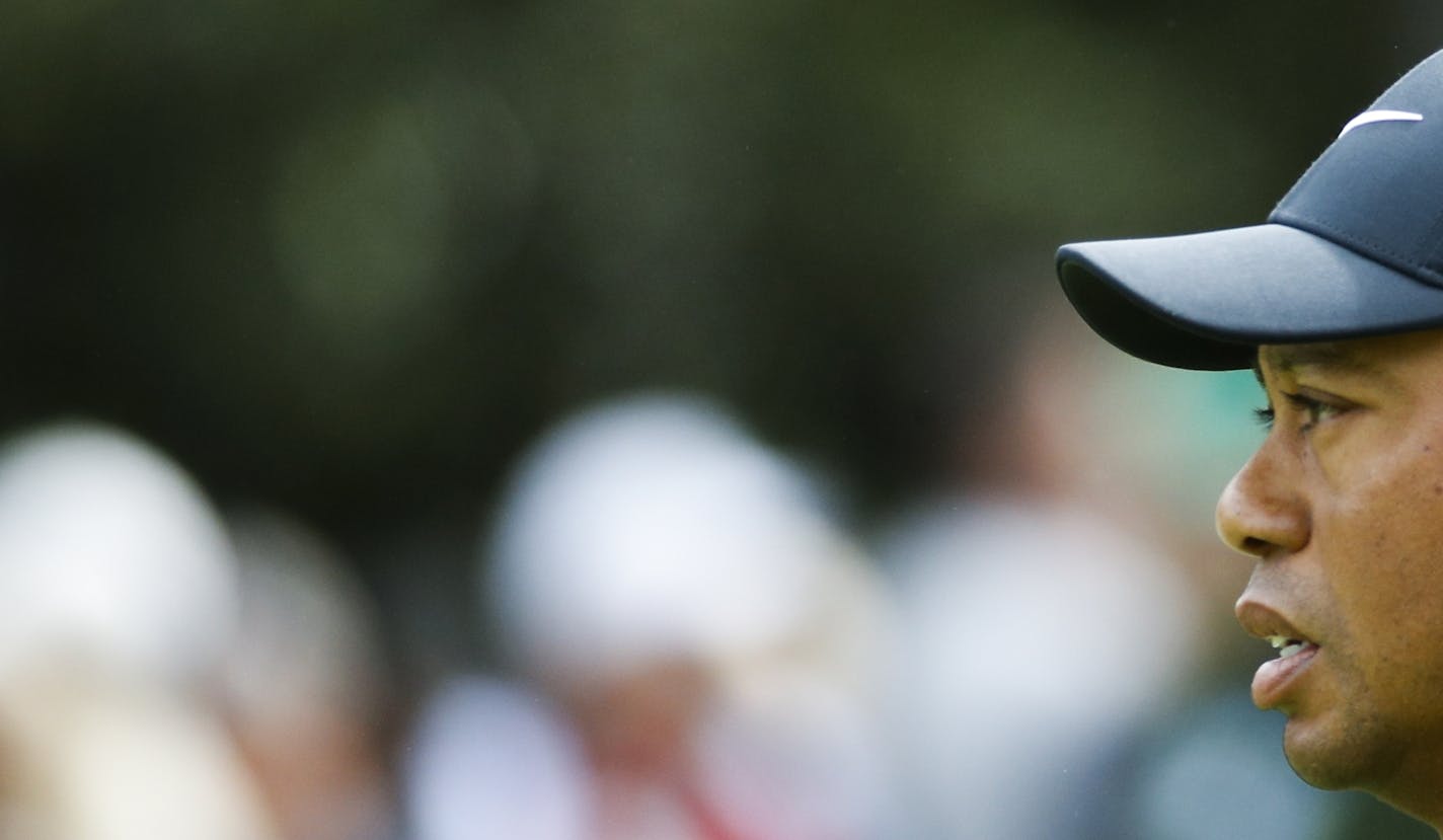 Tiger Woods walks up the first fairway during the fourth round at the Masters golf tournament Sunday, April 8, 2018, in Augusta, Ga. (AP Photo/Charlie Riedel)