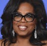 FILE - In this Jan. 7, 2018, file photo, Oprah Winfrey poses in the press room with the Cecil B. DeMille Award at the 75th annual Golden Globe Awards 